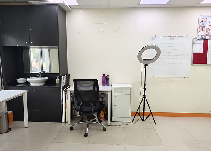 Professional makeup studio at VLCC Chromepet with desks, ring light, and training
                     tools.